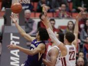 Washington guard Matisse Thybulle, left, shoots against Washington State guard Malachi Flynn (22) and forward Drick Bernstine during the first half of an NCAA college basketball game in Pullman, Wash., Saturday, Jan. 6, 2018.