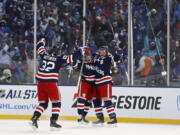 New York Rangers left wing J.T. Miller (10) celebrates scoring the game winning goal with Rangers right wing Mats Zuccarello (36) and Rangers defenseman Kevin Shattenkirk (22) against the Buffalo Sabres in overtime of the NHL Winter Classic hockey game at CitiField in New York on Monday, Jan. 1, 2018. The Rangers won 3-2.