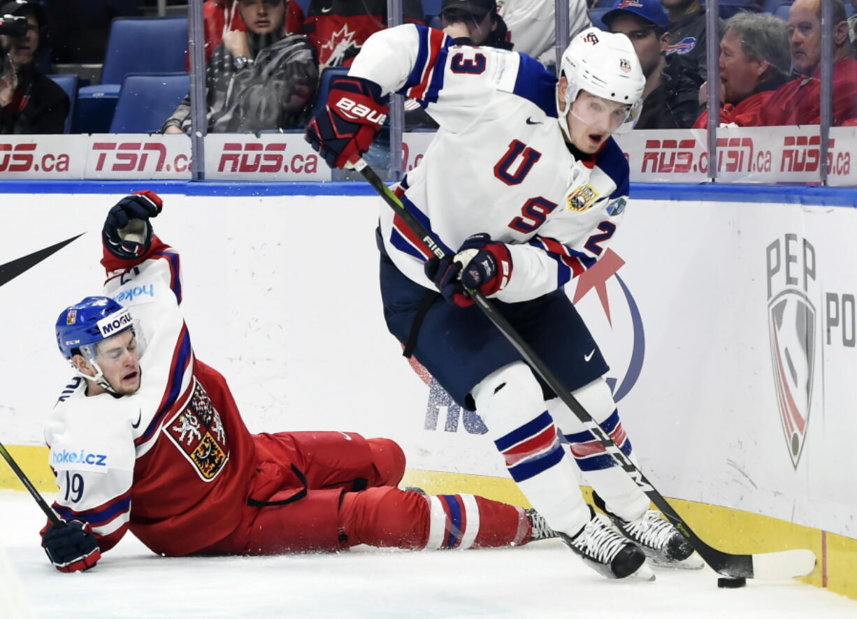 United States forward Kieffer Bellows (23) carries the puck as Czech Republic defenseman Vojtech Budik (19) falls during third-period bronze medal game IIHF world junior championship hockey action in Buffalo, N.Y., Friday, Jan. 5, 2018.