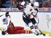 United States forward Kieffer Bellows (23) carries the puck as Czech Republic defenseman Vojtech Budik (19) falls during third-period bronze medal game IIHF world junior championship hockey action in Buffalo, N.Y., Friday, Jan. 5, 2018.