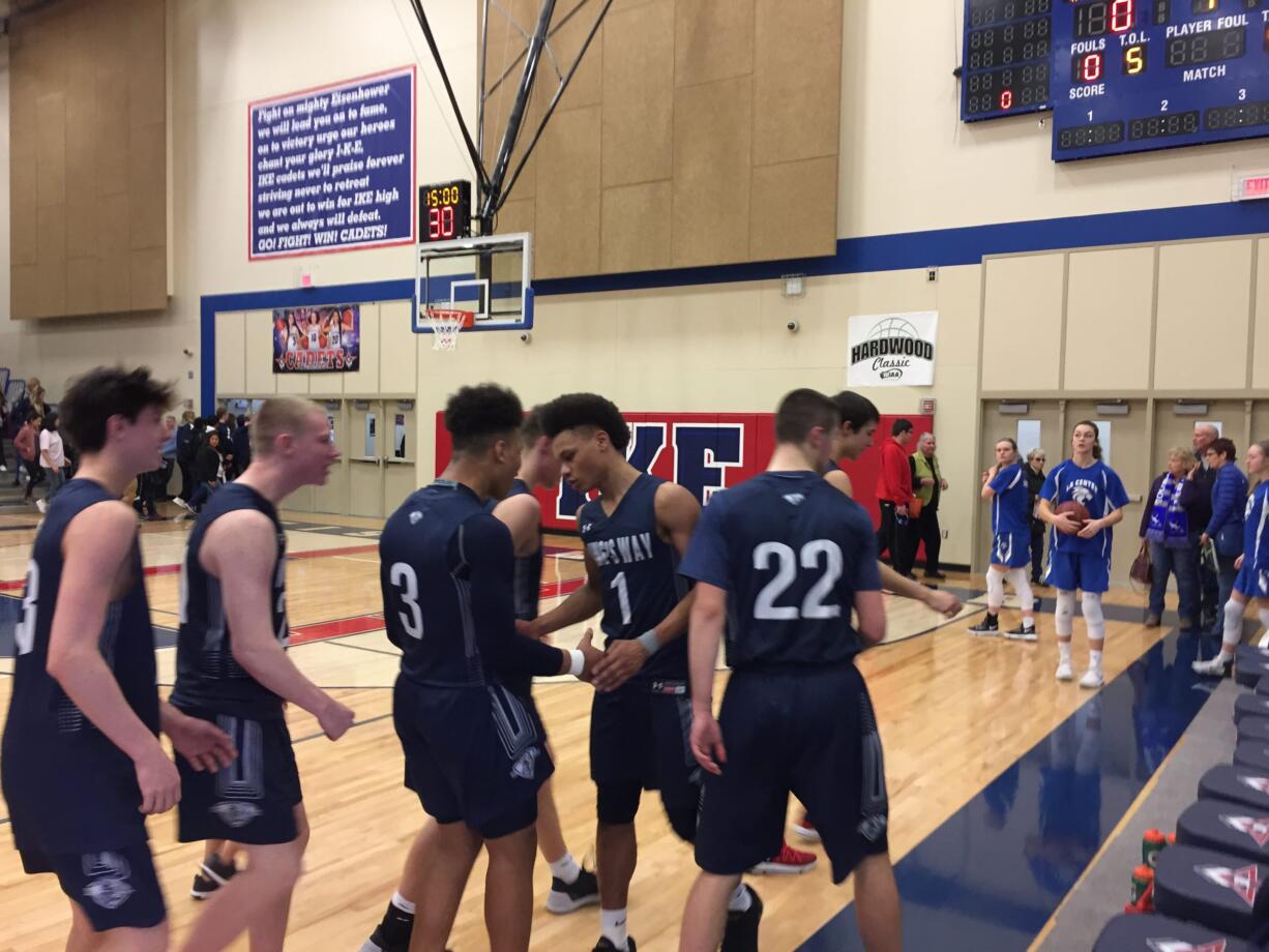 Khalfani Cason (1) is greeted by his King's Way Christian teammates after the junior scored 35 points in a 71-67 overtime win over Wahluke in the Class 1A state basketball tournament Saturday in Yakima.