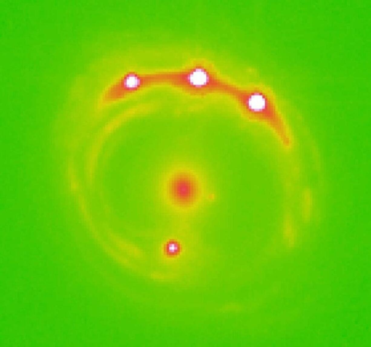 The lens galaxy, at center, and four lensed background quasars.