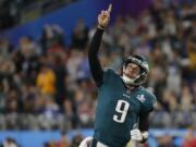 Philadelphia Eagles quarterback Nick Foles gestures after throwing a touchdown pass to wide receiver Alshon Jeffery on Sunday during the first half of the Super Bowl against the New England Patriots.