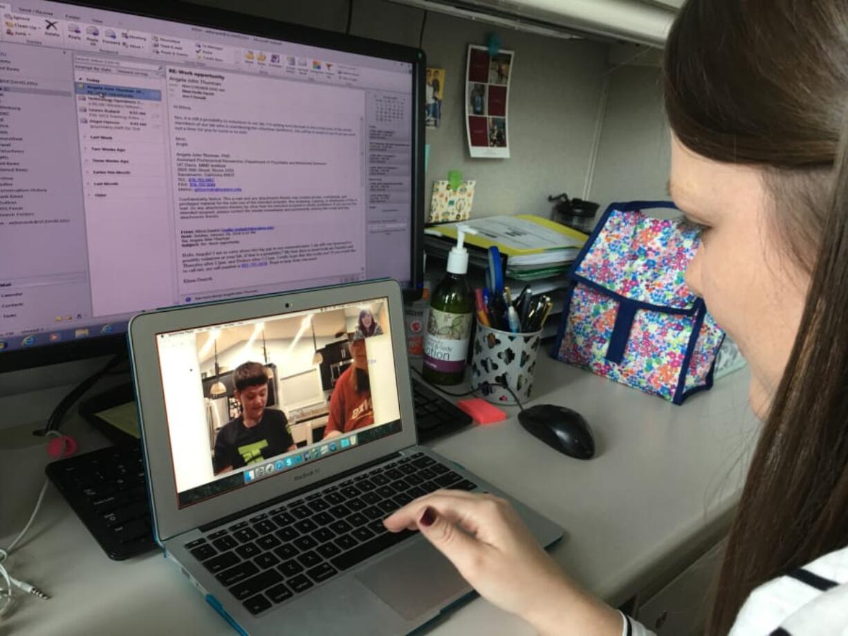 Speech language clinician Amy Banasik coaches Kristen Lundstrom over Skype in her use of strategies to help her son, Tyson, expand his sentences and use new words.