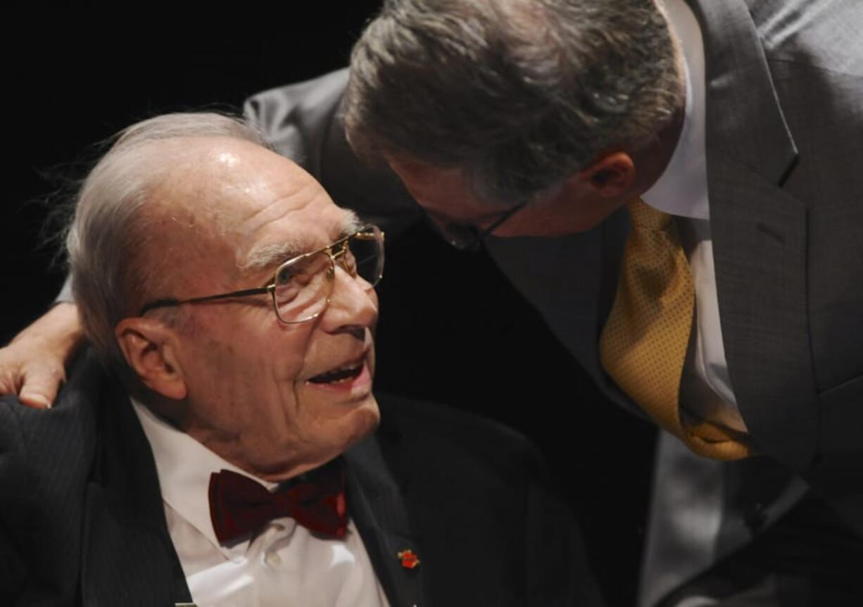 Dan Ogden is greeted by Gov. Jay Inslee during Val Ogden’s memorial service at Clark College on April 26, 2014. Dan Ogden, who died Wednesday, was part of creating national systems for trails and wild scenic rivers 50 years ago.