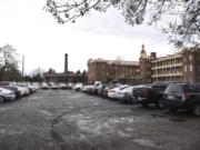 Mixed-use buildings are proposed to replace Providence Academy’s parking lot along C Street, pictured in January. Some are concerned the buildings, which will house apartments and retail space, will block or diminish the 19th century building nearby.