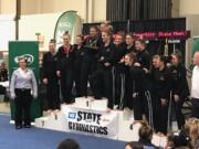 The Camas gymnastics team celebrates its team title at the 4A state meet in Tacoma.