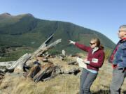 Jessica Walz with Bob Digenthaler, right, both from the Gifford Pinchot Task Force, points in 2011 to the area where the Ascot Mining Company wants to do more exploratory drilling above the Green River and on the border of the Mount St. Helens National Volcanic Monument near Randle.