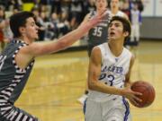 La Center's Hunter Ecklund steps past Montesano's Trevor Ridgway in the first quarter of the 1A State Regional game at Mark Morris High School.