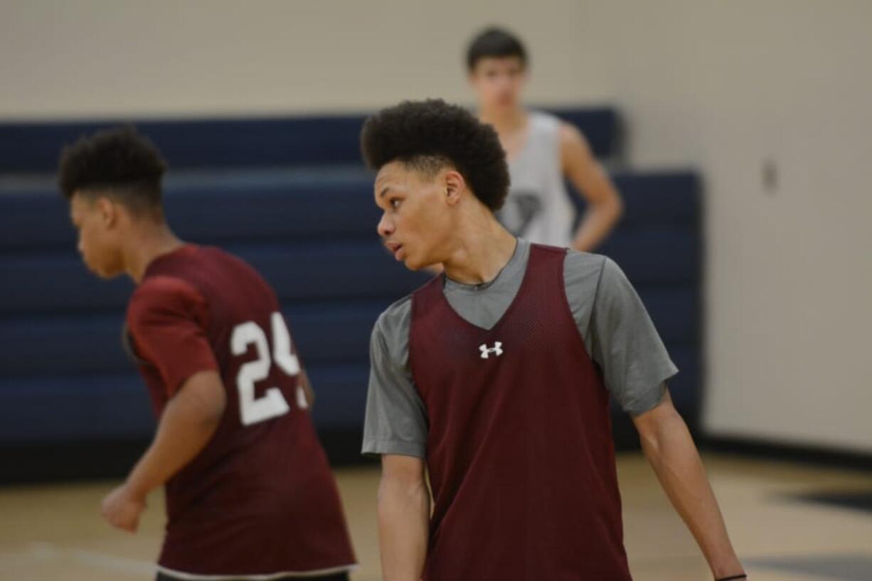 King's Way guard Khalfani Cason tracks a player on defense during the Knights' practice on Monday Feb.