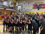 The Union girls basketball team celebrates a 48-37 victory over Todd Beamer in the regional round of the Class 4A state tournament on Friday in Puyallup.