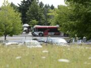 A C-Tran bus is seen in July from an empty field at Fisher's Landing Transit Center, where C-Tran is planning to build a new transit-oriented development.