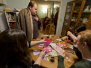 Art night with the Otton family (and some friends). Geoffrey Otton, at center in brown blanket, is 29 and lives with severe autism. Every Saturday night his family, friends and neighbors gather to visit him and each other during a brief social hour — while keeping their hands busy with simple art projects like making valentines. On a recent Saturday he was joined by Mariah Huerena, 17 (left), Hunter Yost, 18, and sister Linda Otton, 26. Geoffrey’s father, Ed Otton, in the background, was nursing a cold and staying away from the company that night.