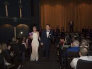 Tami Weidert and Nick Calais make their way up the aisle at Liberty Theatre in Camas after taking their wedding vows Friday afternoon. Wedding guests received movie popcorn before the ceremony, and a slideshow featuring the couple played on the big screen.