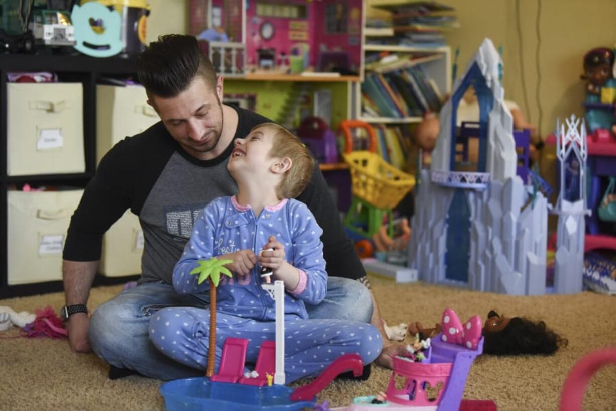 Justin Hayden listens as his daughter, Gwenyth, 5, talks about her dolls while playing together on a recent Wednesday. Gwenyth was diagnosed with acute lymphoblastic leukemia in January 2017.