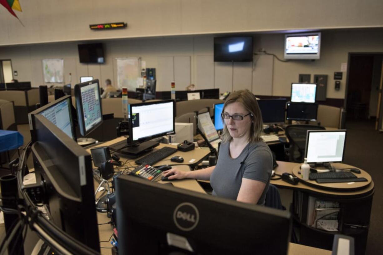 Dispatch supervisor Jodi Gaylord of Vancouver takes calls at Clark Regional Emergency Services Agency in downtown Vancouver. Gaylord said she listens for clues during calls that human trafficking may be taking place so she can alert officers responding to the scene.
