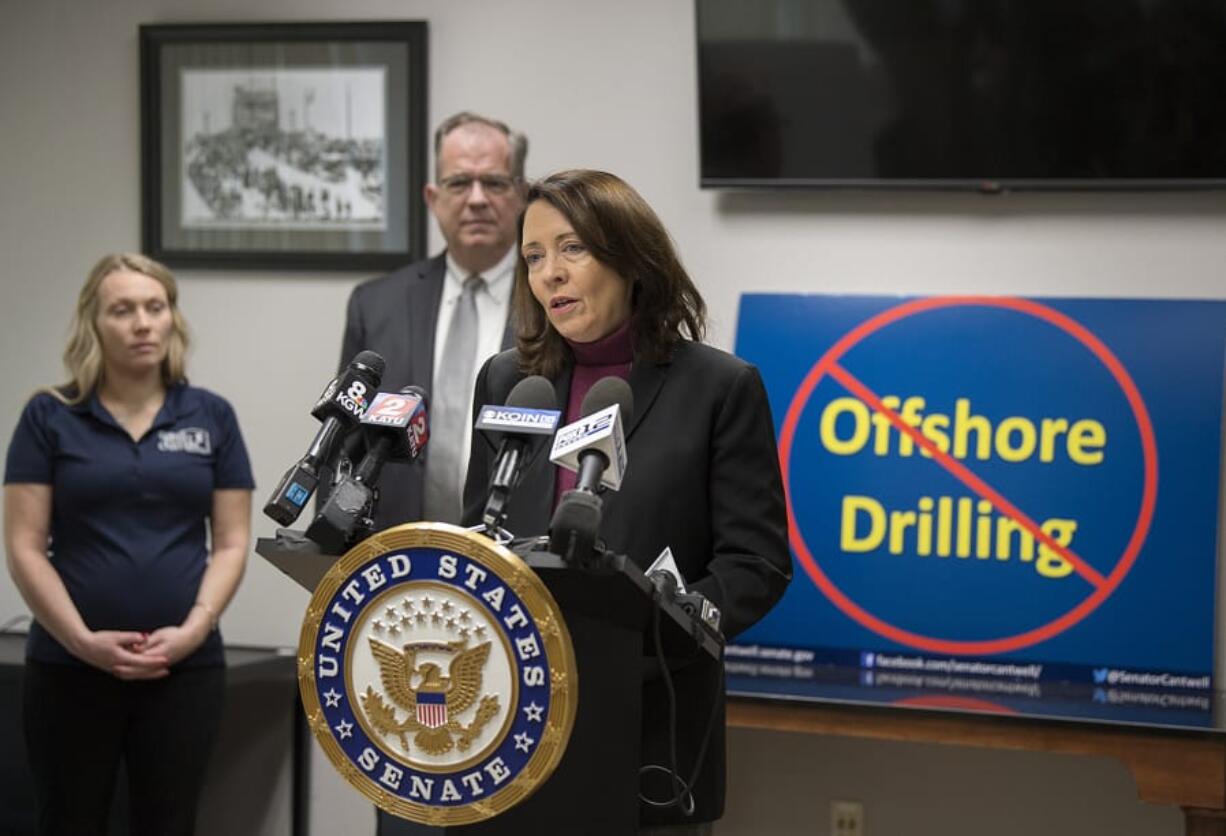 Kathleen Nisbet-Moncy of Nisbet Oyster Co. & Goose Point Oyster Co., from left, and Paul Montague III of the Greater Vancouver Chamber of Commerce listen as Sen. Maria Cantwell speaks out against offshore drilling in downtown Vancouver on Thursday.