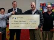 East Mill Plain: Clark Public Utilities gave Evergreen Public Schools a rebate check for energy upgrades in the district. From left: Todd Yuzuriha, president of the school board, Superintendent John Steach, Bill Hibbs, Clark Public Utilities commercial energy efficiency manager, and Jeff Taylor, manager with Columbia Electric Supply.