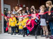 Vancouver Mayor Anne McEnerny-Ogle gets some help cutting the ribbon for Vancouver Fire Department’s Fire Station 2 on Saturday. Many attended the event, including young families and children who hoped to become firefighters.