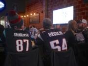 A group of New England Patriot fans watch the Super Bowl on Sunday afternoon at the Main Event Sports Grill in downtown Vancouver.