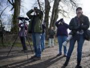 Cindy McCormack of Vancouver, left, Randy Hill of Ridgefield, Marie Marshall of Vancouver, Suzanne Setterberg of Ridgefield, and Michelle Maani of Vancouver watch red-winged blackbirds fly overhead during a birding trip with the Vancouver Audubon Society on a recent Saturday morning in the Woodland Bottoms. The group goes on birding field trips regularly throughout the year, and newcomers are always welcome.