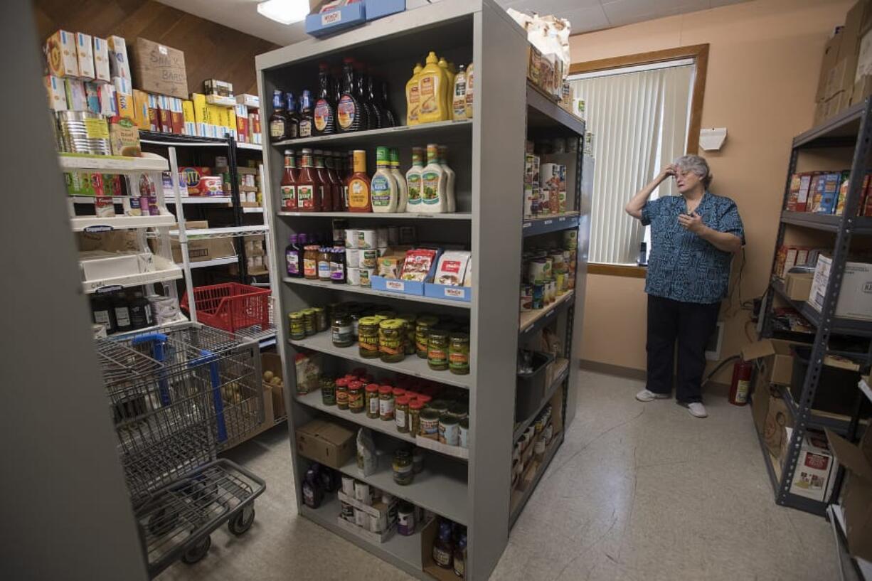 Executive Director Vicki Smith inventories donated food and hygiene items at Martha’s Pantry, a community resource and social network for people with HIV/AIDS. Three people connected with the pantry have died in recent weeks. Facing the loss never gets any easier, Smith said.