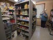 Executive Director Vicki Smith inventories donated food and hygiene items at Martha’s Pantry, a community resource and social network for people with HIV/AIDS. Three people connected with the pantry have died in recent weeks. Facing the loss never gets any easier, Smith said.