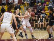 Prairie’s Brooke Walling (12) guards against Bonney Lake’s Olivia Grob (10) during the first round of the 3A bi-district girls basketball tournament at Prairie High School, Wednesday February 7, 2018.