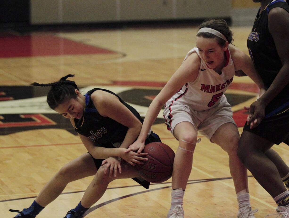 Jillian Webb of Camas, left, battles for a loose ball with Meera Santos of Hazen in the 4A girls basketball bi-district tournament at Camas high school.