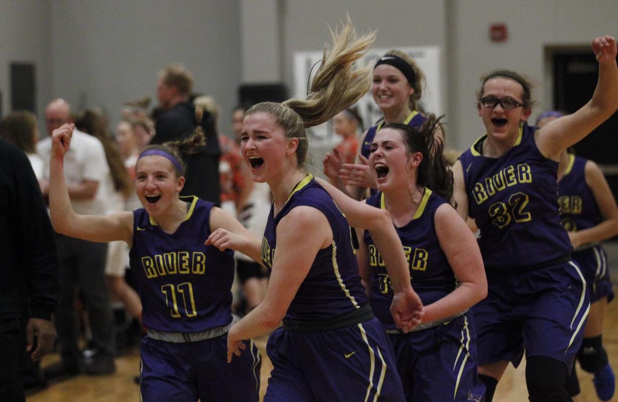 Columbia River players left to right, Lily Jonas, Katie Kolbe, Erin Baker and Ellie Christian react to defeating Washougal in first round of the 2A district girls basketball tournament.