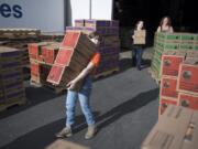 Girl Scout troops from Southwest Washington and the Portland area gather for depot day, moving more than 500,000 boxes of cookies from a Vancouver warehouse into cars, trucks, horse trailers and U-Hauls. Kira Louvier, 11, of Vancouver helps move cookies into a van on Saturday.