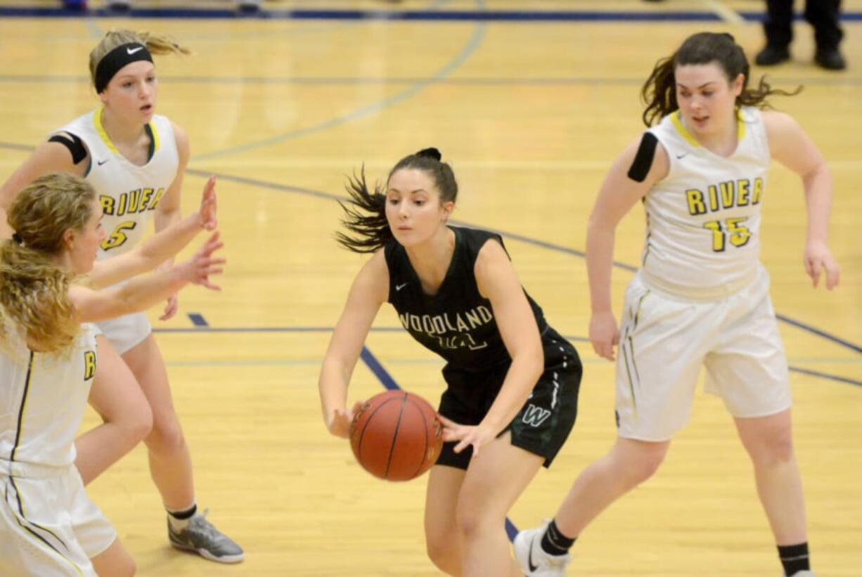 Woodland senior Dana Glovick squeezes a pass off during a 2A district tournament against Columbia River at Ridgefield High School on Thursday, February 14, 2018.