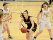 Woodland senior Dana Glovick squeezes a pass off during a 2A district tournament against Columbia River at Ridgefield High School on Thursday, February 14, 2018.