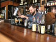 Bartender Ryan Shorthouse makes a Power Queen cocktail at The Grocery Cocktail & Social in Vancouver.