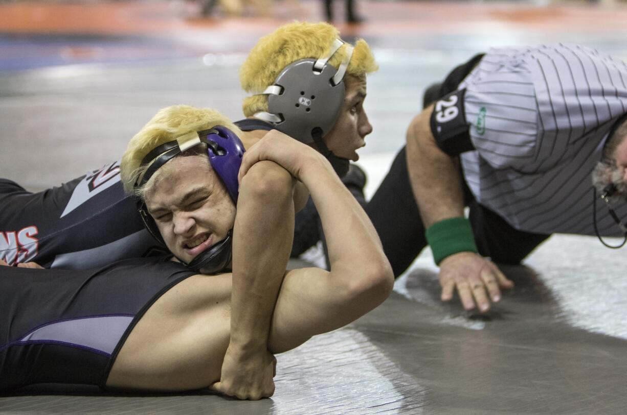 Union's Danny Snediker on his way to pinning Kamiak's Guage Holland during their 4A State Wrestling opening round match in the 152 lb. weight class Friday, Feb. 16, 2018, at the Tacoma Dome in Tacoma, Wash.