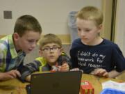 Washougal: Hathaway Elementary School students, from left, Cole Wilson, Carter Boucher and Leo Perry at a workshop put on by the Washougal School District and Washougal Community Library to give students hands-on experience learning about circuits, electricity and conductors.