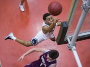 Skyview’s Jovon Sewell (2) launches into the air to make a shot during the 4A regional game against Enumclaw at Battle Ground High School, Saturday February 24, 2018.