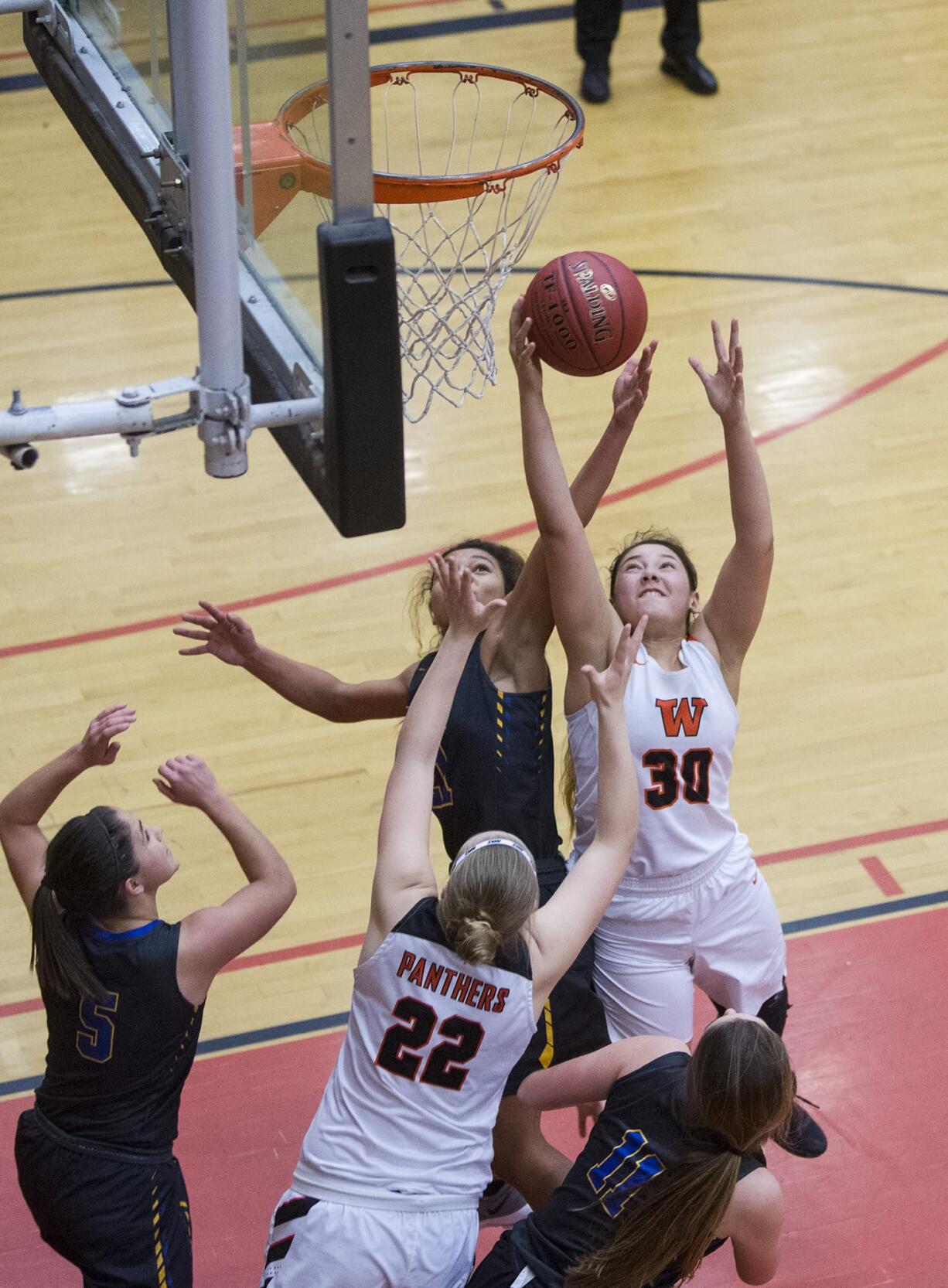 Washougal’s Tiana Barnett (30) makes a shot past Fife’s Aliya Hunter (21) during the 2A regional girls basketball game at Battle Ground High School, Saturday February 24, 2018.