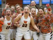 Washougal girls basketball players scream with excitement after receiving their medal for winning the 2A regional girls basketball game against Fife at Battle Ground High School, Saturday February 24, 2018.