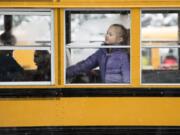 Pleasant Valley Primary School third-grader Madison Bohac watches her classmates file past as they load onto buses for early release on Tuesday morning. The school let out at 10:30 a.m. because of heavy snowfall predicted throughout the day.