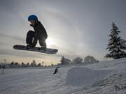 Solomon Albrecht, 10, of Vancouver catches some air off a makeshift jump while snowboarding at Franklin Elementary School on Wednesday morning, Feb. 21, 2018. Albrecht, who is a fourth-grader at the school, was one of hundreds of local kids who had the day off from school because of the snowy weather.