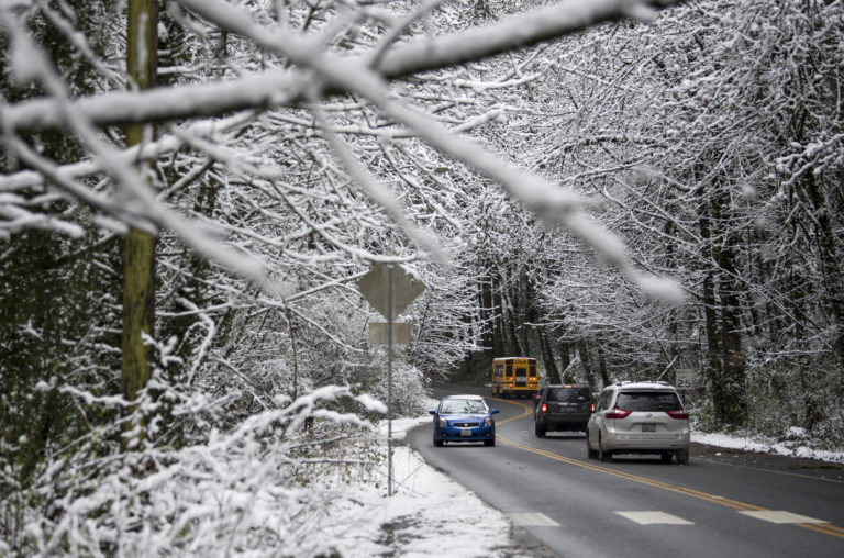 Many local schools operated with a late start on Thursday morning, but because temperatures lingered just above freezing the freeways and metro-area streets were mostly bare. Drivers are seen along Blandford Drive canyon from MacArthur Boulevard to Evergreen Boulevard late Thursday morning, Feb. 22, 2018, in Vancouver.