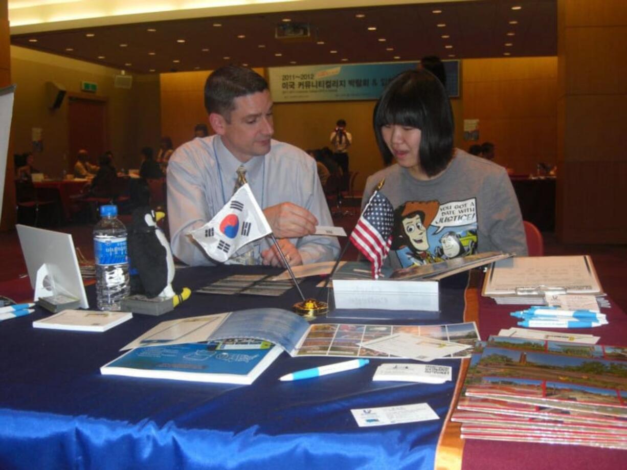 Vice President of Student Affairs Bill Belden talks with a prospective student in South Korea during a recruitment trip.