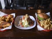 From left to right, grilled cheese with tomato on sourdough bread, a half wedge salad and the Renegade Kicker Burger are pictured at Renegades Bar & Grill in downtown Vancouver, Friday February 23, 2018.