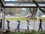 First-graders walk back to their classrooms after enjoying a meal of green eggs and ham at Marrion Elementary School on Tuesday morning in Vancouver. The school kicked off Read Across America week with a colorful breakfast, donated by Beaches Restaurant & Bar, in honor of Dr. Seuss’ beloved children’s books. Beaches owner Mark Matthias and a team of volunteers have been feeding green eggs and ham to students for 23 years.