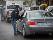 Trooper Will Finn talks to a driver with Oregon license plates after she was pulled over near Harney Elementary School on Monday morning. The driver pictured was not given a ticket because she was just dropping off her nephews.