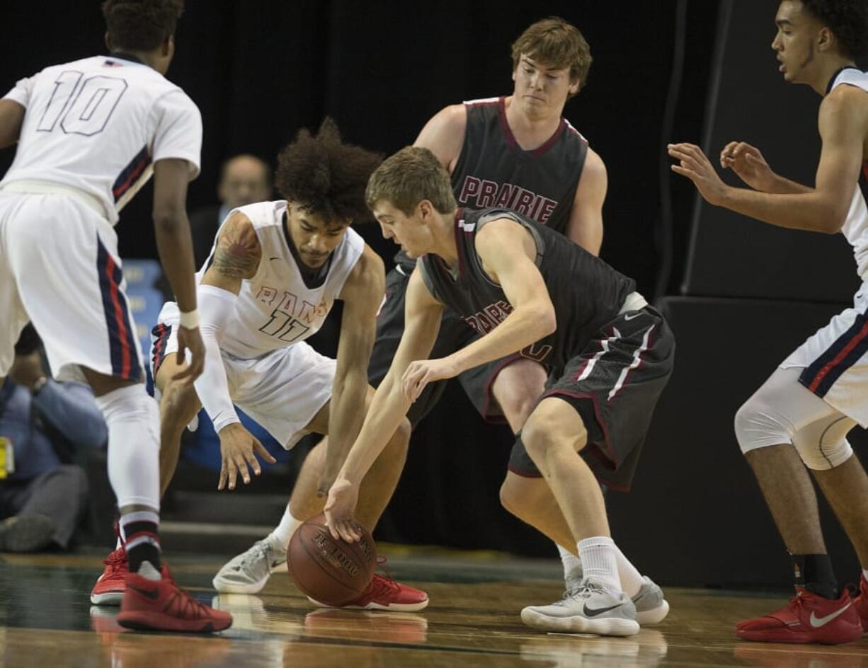 Wilson’s Darrian Bates (11) battles Prairie’s Dante Heitschmidt (2) for a loose ball in the first quarter at the Tacoma Dome on Wednesday afternoon, Feb. 28, 2018.