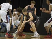 Wilson’s Darrian Bates (11) battles Prairie’s Dante Heitschmidt (2) for a loose ball in the first quarter at the Tacoma Dome on Wednesday afternoon, Feb. 28, 2018.