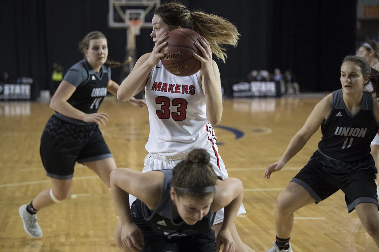 Camas' Courtney Clemmer (33) pulls down a rebound over a crowd of Union defenders in the first quarter at the Tacoma Dome on Wednesday afternoon, Feb. 28, 2018.