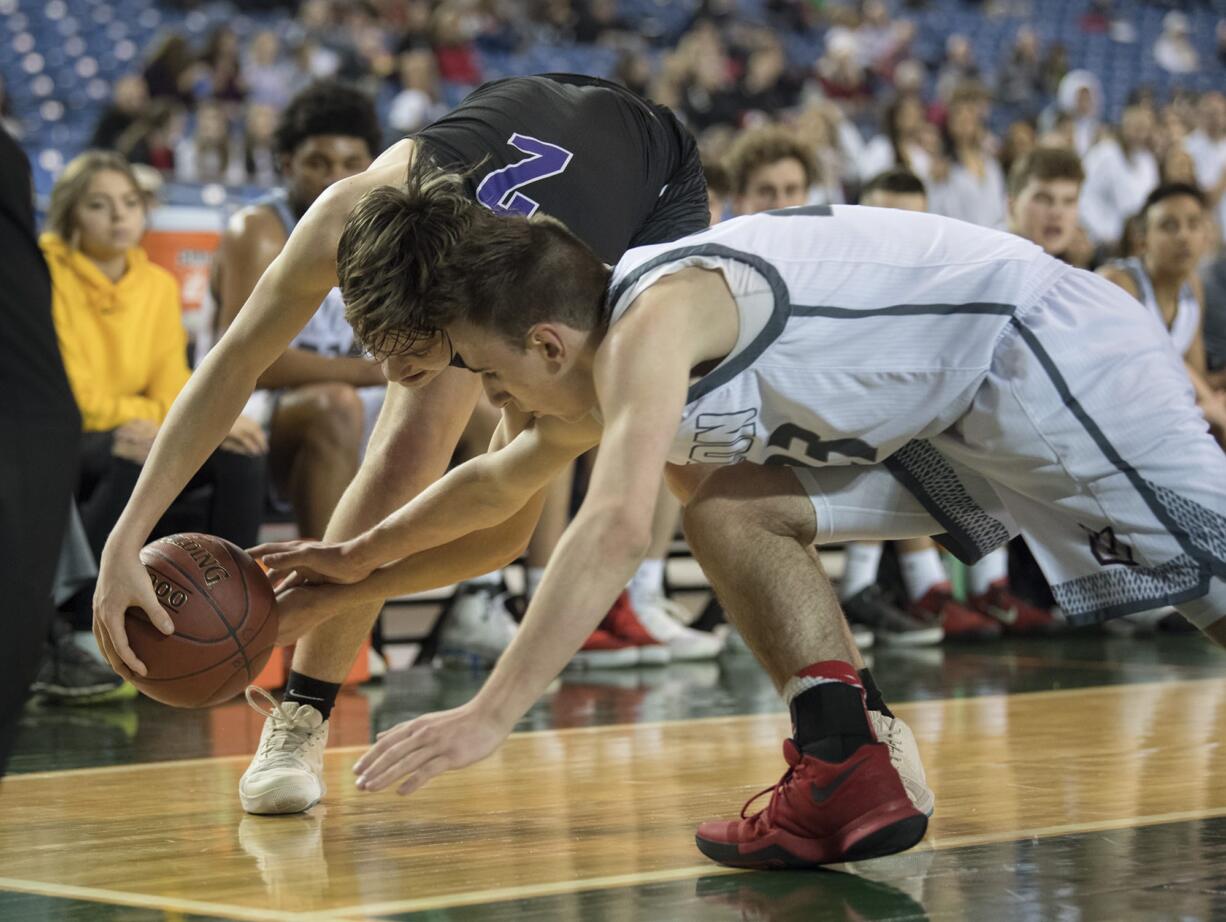 Kamiak's Dakota Bueing (2) fights Union's Ethan Smith (23) for a loose ball in the second half at the Tacoma Dome on Wednesday afternoon, Feb. 28, 2018.